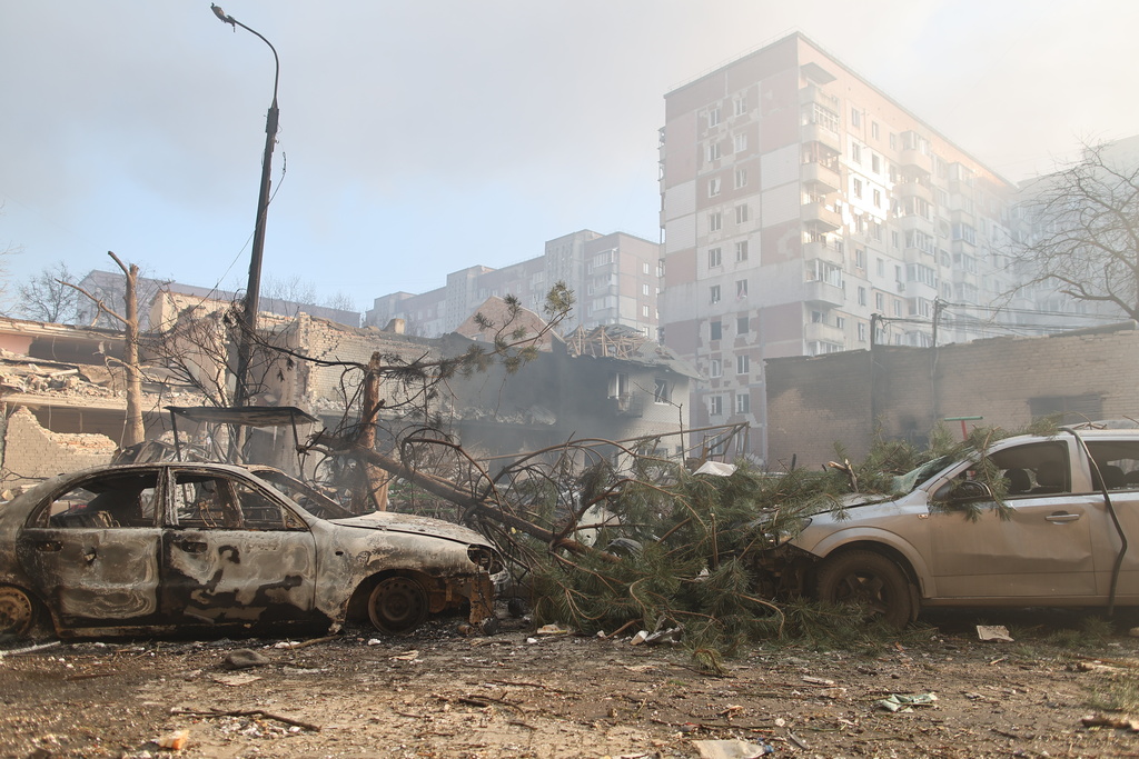 Burnt cars are seen in front of a residential building which was heavily damaged after a Russian strike on Ternopil, Ukraine, on Wednesday, Nov. 19, 2025. (AP Photo/Vlad Kravchuk)
