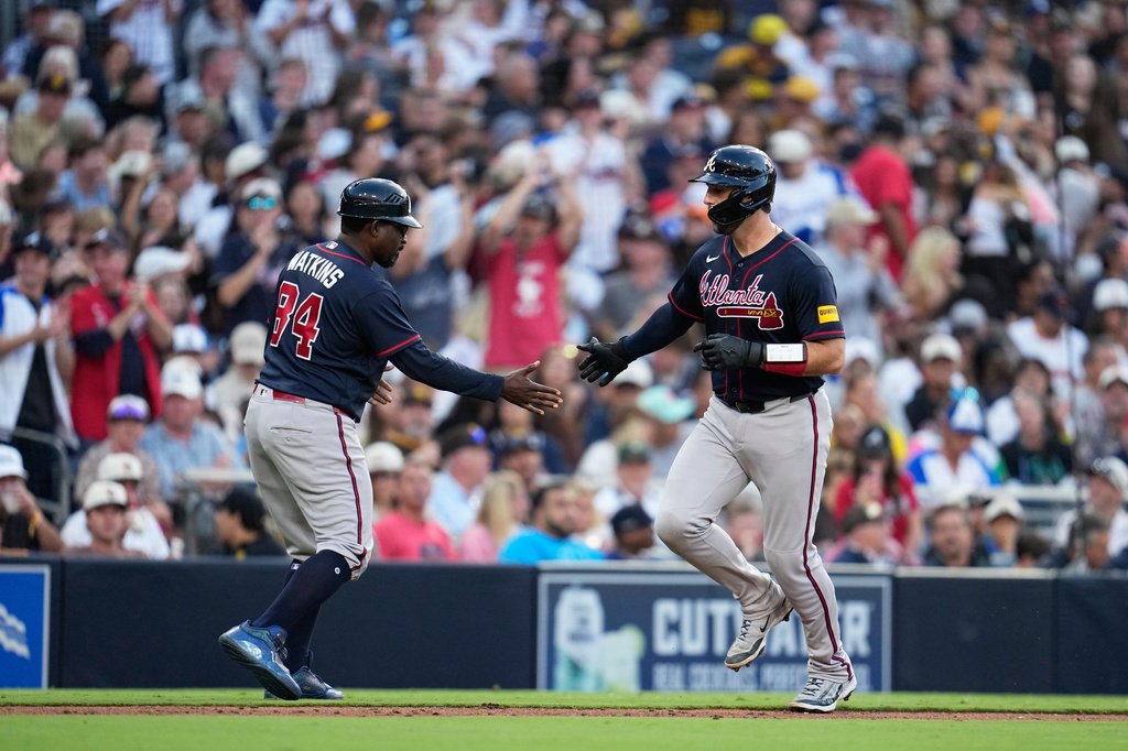 Atlanta Braves' Joey Bart, right, celebrates with third base coach Tommy Watkins after hitting a two-run home run during the sixth inning of a baseball game against the San Diego Padres Wednesday, June 24, 2026, in San Diego. (AP Photo/Gregory Bull)