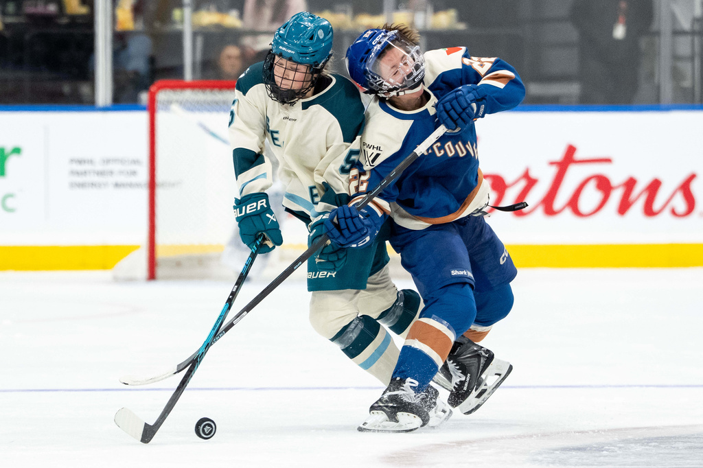 Seattle Torrent's Anna Wilgren (5) and Vancouver Goldeneyes' Abby Boreen (22) collide during the second period of a PWHL hockey game in Vancouver, on Tuesday, April 14, 2026. (Ethan Cairns/The Canadian Press via AP)