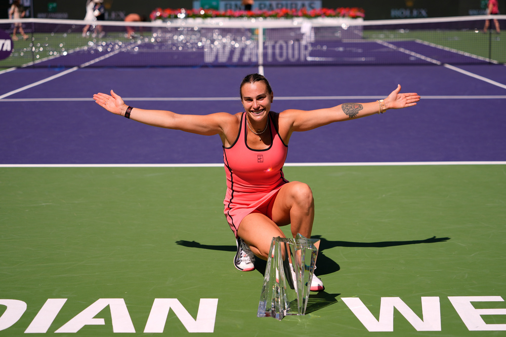 Aryna Sabalenka, of Belarus, poses for photos after defeating Elena Rybakina, of Kazakhstan, to win the BNP Paribas Open tennis tournament Sunday, March 15, 2026, in Indian Wells, Calif. (AP Photo/Mark J. Terrill)