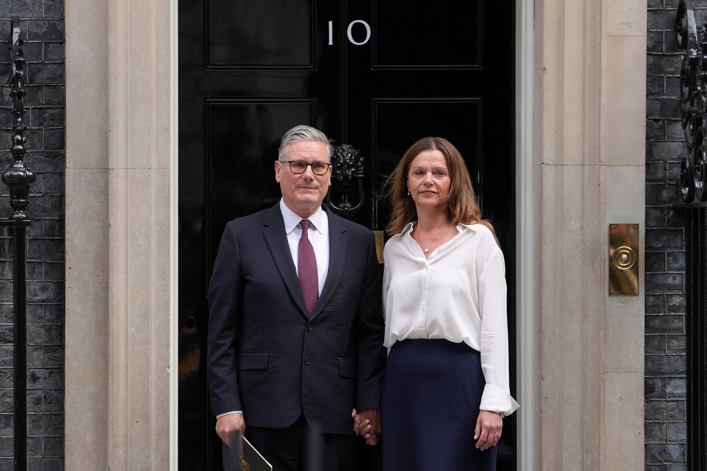 Britain's Prime Minister Keir Starmer and wife Victoria stand in front of 10 Downing Street door after announcing his resignation to the media in London, Monday, June 22, 2026.(AP Photo/Kin Cheung)