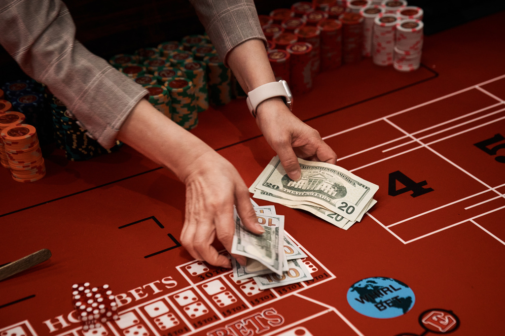 A dealer counts cash over a craps table during the opening of live table games at the casino at Resorts World New York City on Tuesday, April 28, 2026, in New York. (AP Photo/Andres Kudacki)