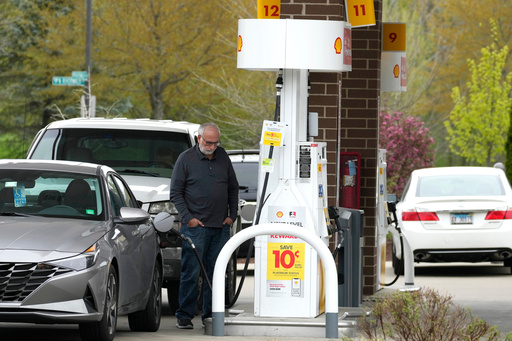 FILE - A customer fills up his vehicle's gas tank at a gas station in Buffalo Grove, Ill., April 23, 2024. (AP Photo/Nam Y. Huh, file) FILE - A customer fills up his vehicle's gas tank at a gas station in Buffalo Grove, Ill., April 23, 2024. (AP Photo/Nam Y. Huh, file)