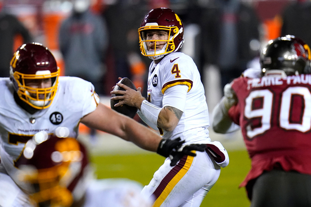FILE - Washington Football Team quarterback Taylor Heinicke (4) looks to pass against the Tampa Bay Buccaneers during the second half of an NFL wild-card playoff football game, Jan. 9, 2021, in Landover, Md. (AP Photo/Julio Cortez, File)