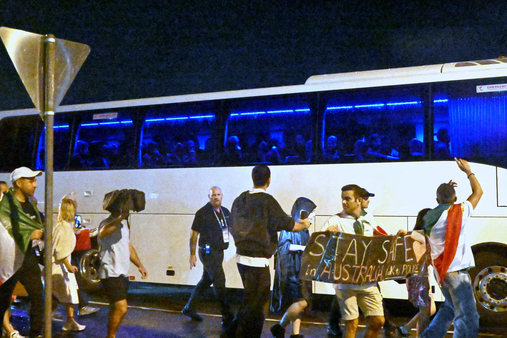 Supporters react towards a bus transporting Iranian woman players following their Women's Asian Cup soccer match against the Philippines on the Gold Coast, Australia, Sunday, March 8, 2026. (Dave Hunt/AAP Image via AP))