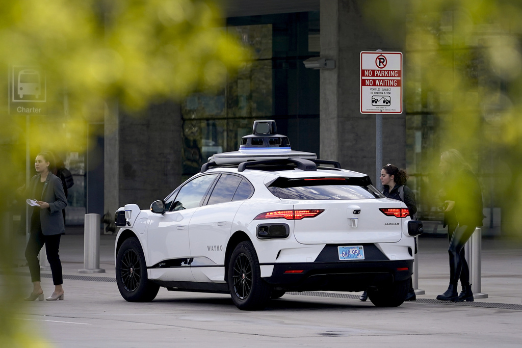 FILE - A Waymo self-driving vehicle sits curbside, Dec. 16, 2022, at the Sky Harbor International Airport Sky Train facility in Phoenix. (AP Photo/Matt York, File)