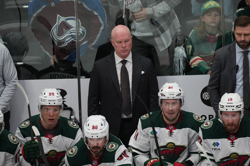 FILE - Minnesota Wild head coach John Hynes looks on in the first period of Game 2 of an NHL hockey Stanley Cup second-round playoff series on May 5, 2026, in Denver. (AP Photo/David Zalubowski, File)