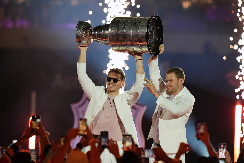 Florida Panthers's Matthew Tkachuk, left, and Aleksander Barkov hold up the Stanley Cup at the NHL Winter Classic outdoor hockey game, Friday, Jan. 2, 2026, in Miami. (AP Photo/Lynne Sladky)