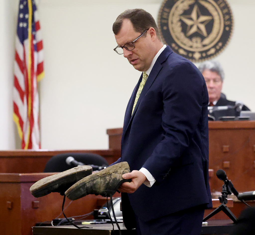 Wise County District Attorney James Stainton holds the shoes Tanner Horner wore when he killed Athena Strand during the punishment phase of the trial Tuesday, May 5, 2026, at the Tim Curry Criminal Justice Center in Fort Worth, Texas. (Amanda McCoy/Star-Telegram via AP)