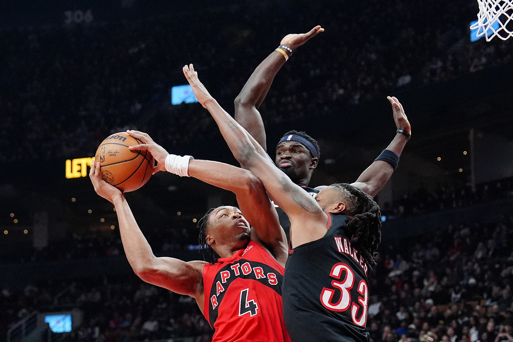 Toronto Raptors forward/guard Scottie Barnes (4) is fouled on his way to the hoop by Philadelphia 76ers forward Jabari Walker (33) as 76ers' Adem Bona, top, looks on during first-half NBA basketball game action in Toronto, Sunday, Jan. 11, 2026. (Frank Gunn/The Canadian Press via AP)