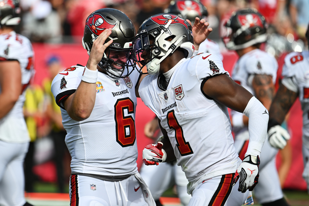 Tampa Bay Buccaneers running back Rachaad White (1) is congratulated by quarterback Baker Mayfield (6) after scoring against the San Francisco 49ers during the first half of an NFL football game in Tampa, Fla., Sunday, Oct. 12, 2025. (AP Photo/Jason Behnken)