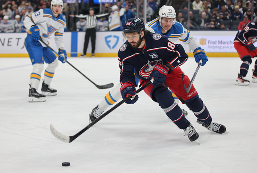 Columbus Blue Jackets forward Kirill Marchenko, left, reaches for the puck in front of St. Louis Blues forward Nick Bjugstad during the first period of an NHL hockey game in Columbus, Ohio, Saturday, Nov. 1, 2025. (AP Photo/Paul Vernon) Columbus Blue Jackets forward Kirill Marchenko, left, reaches for the puck in front of St. Louis Blues forward Nick Bjugstad during the first period of an NHL hockey game in Columbus, Ohio, Saturday, Nov. 1, 2025. (AP Photo/Paul Vernon)