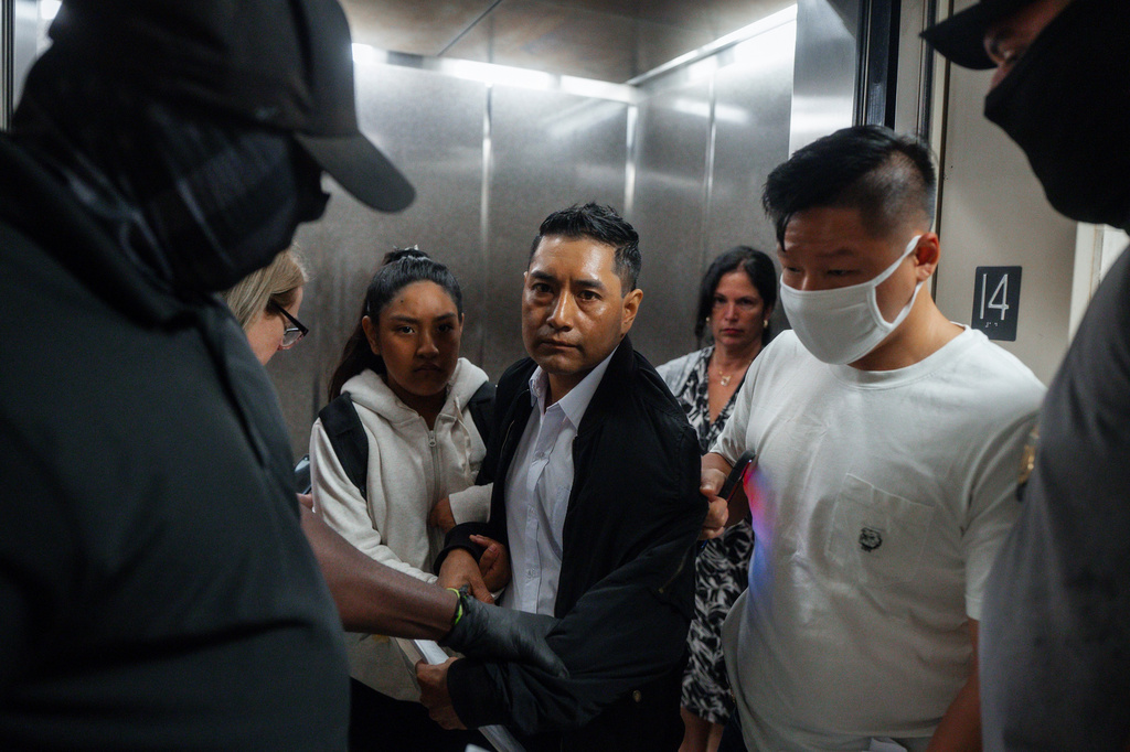 FILE - Immigration and Customs Enforcement agents pull a man out of an elevator as he and his daughter attempt to leave following a hearing in immigration court, Friday, Sept. 5, 2025, in New York. (AP Photo/Olga Fedorova,File)