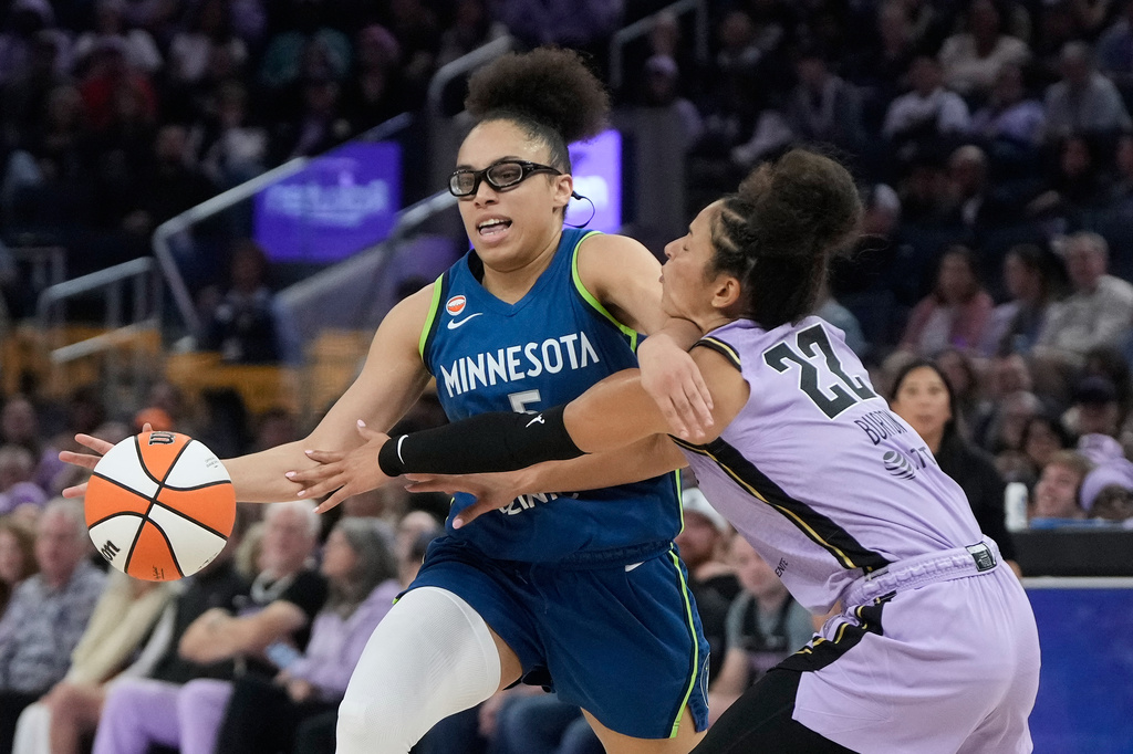 Minnesota Lynx guard Olivia Miles, left, drives to the basket against Golden State Valkyries guard Veronica Burton (22) during the first half of a WNBA basketball game in San Francisco, Wednesday, Aug. 19, 2026. (AP Photo/Jeff Chiu)