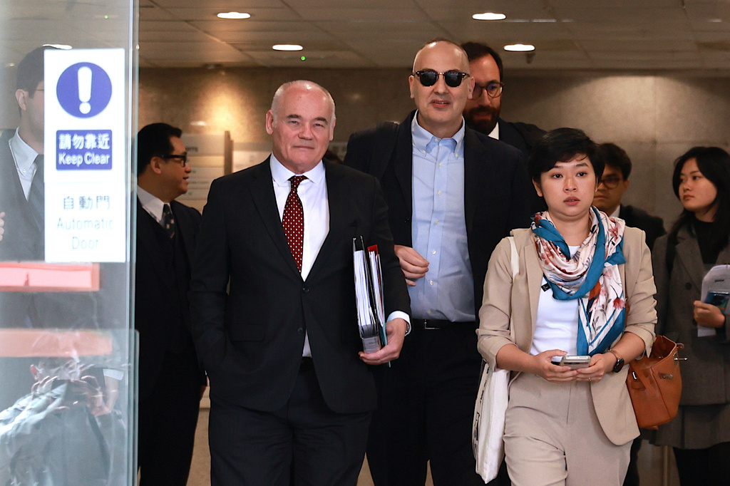 Selina Cheng, right, chair of the Hong Kong Journalists Association (HKJA) and a former reporter for The Wall Street Journal (WSJ), leaves Eastern Magistrates' Court during a session break, together with her legal team, barrister Nicklaus Pannu-Yuon, left, senior counsel Nigel Kat, second left and solicitor Adam Paul Clermont, center back, for her case against the paper's parent company, Dow Jones Publishing Co (Asia) Inc., in Hong Kong on Thursday, Dec. 18, 2025. (AP Photo/May James)
