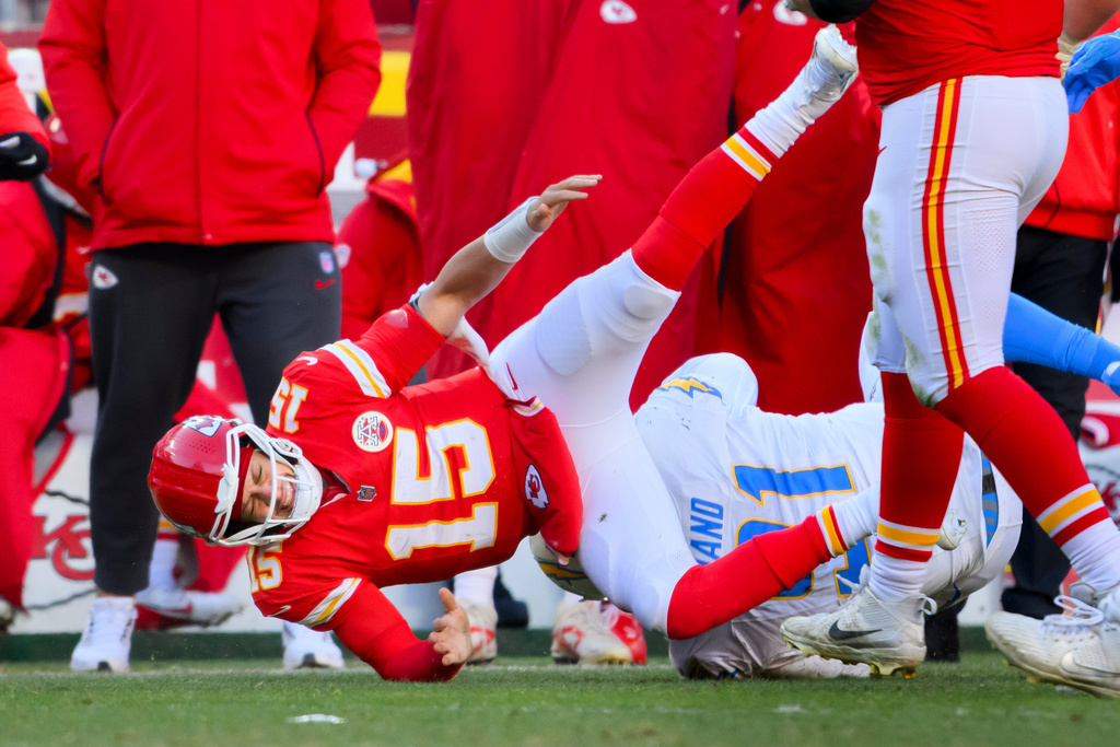Kansas City Chiefs quarterback Patrick Mahomes (15) is injured after being tackled by Los Angeles Chargers defensive tackle Da'Shawn Hand (91) during the second half of an NFL football game, Sunday, Dec. 14, 2025 in Kansas City, Mo. (AP Photo/Reed Hoffmann)