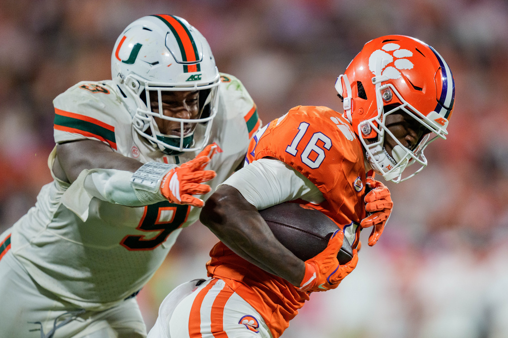 Miami linebacker Chase Smith (9) tackles Clemson running back Chris Johnson Jr. (16) in the second half of an NCAA college football game Saturday, Oct. 3, 2026, in Clemson, S.C. (AP Photo/Jacob Kupferman)