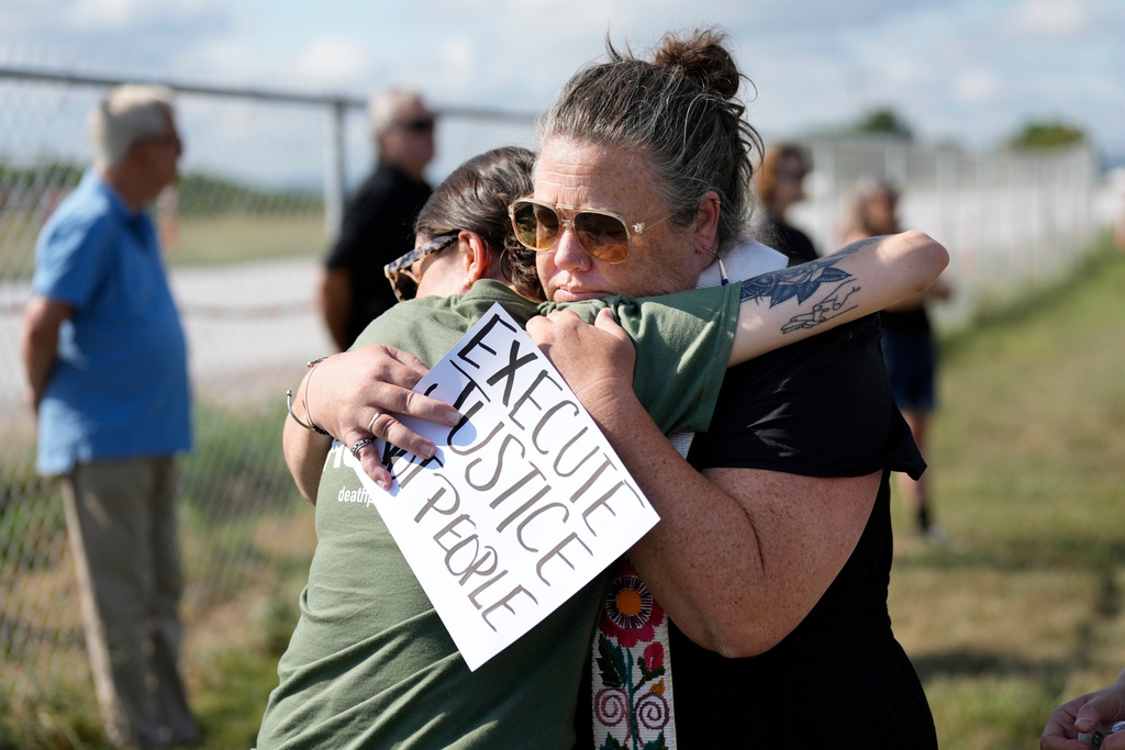 FILE - India Pungarcher, left, hugs Rev. Ingrid McIntyre as demonstrators gather in the area reserved for anti-death penalty protesters outside Riverbend Maximum Security Institution before the execution of Byron Black in Nashville, Tenn., on Tuesday, Aug. 5, 2025. (AP Photo/Mark Humphrey, File)