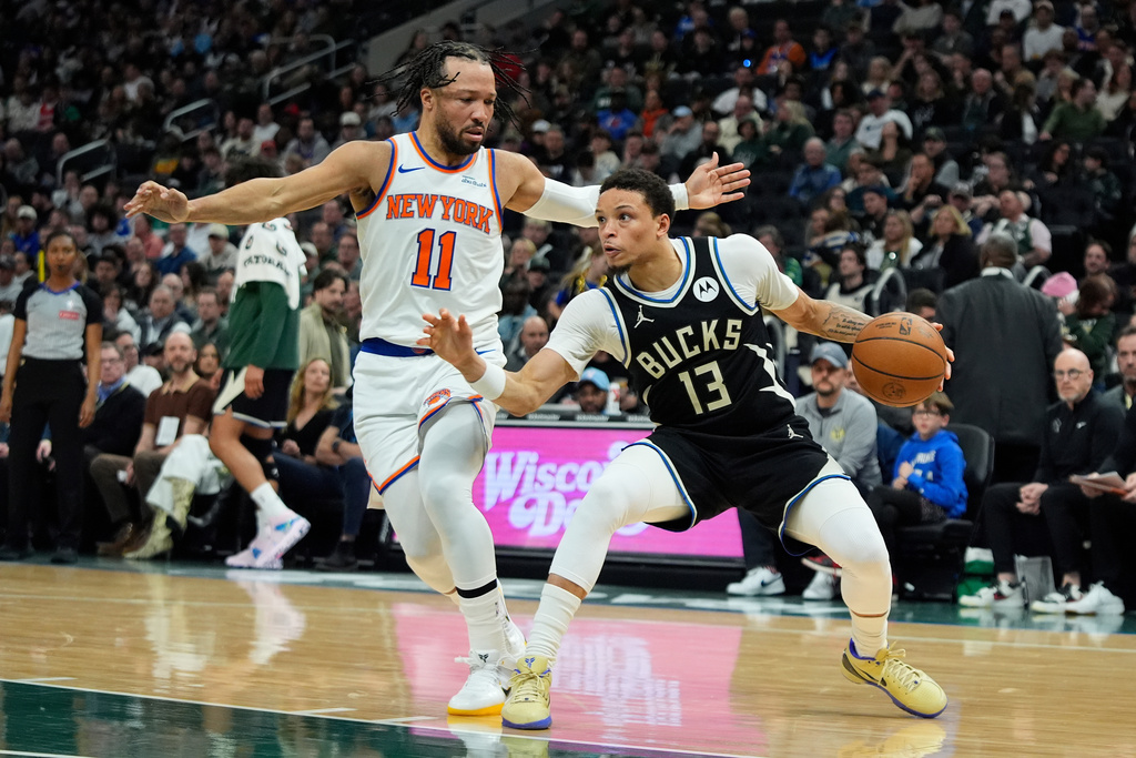 Milwaukee Bucks' Ryan Rollins (13) drives to the basket against New York Knicks' Jalen Brunson (11) during the first half of an NBA basketball game Friday, Feb. 27, 2026, in Milwaukee. (AP Photo/Aaron Gash)