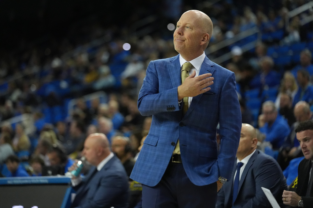 UCLA coach Mick Cronin congratulates his players during the first half of an NCAA college basketball game in Los Angeles, Friday, Nov.21, 2025. (AP Photo/Damian Dovarganes)