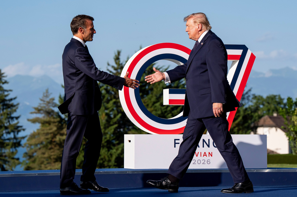Emmanuel Macron, President of France, left, greets U.S. President Donald Trump during the G7 summit in Evian-les-Bains, France, Monday, June 15, 2026. (Christopher Katsarov/The Canadian Press via AP)