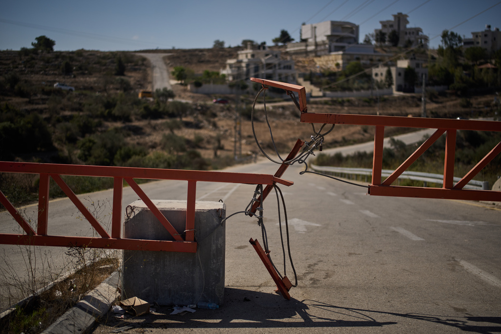 A gate set up by Israeli authorities blocks one of the entrances to the West Bank village of Atara, Tuesday, Sept. 30, 2025. (AP Photo/Leo Correa)