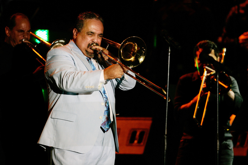 FILE - Willie Colon plays the trombone while performing the song "La Murga" during a tribute concert in honor of the late salsa music pioneer Hector Lavoe in San Juan, Puerto Rico, Sept. 7, 2007. Colón, considered by many to be the "architect of urban salsa," died Saturday, Feb. 21, 2026. He was 75. (AP Photo/Andres Leighton, File)