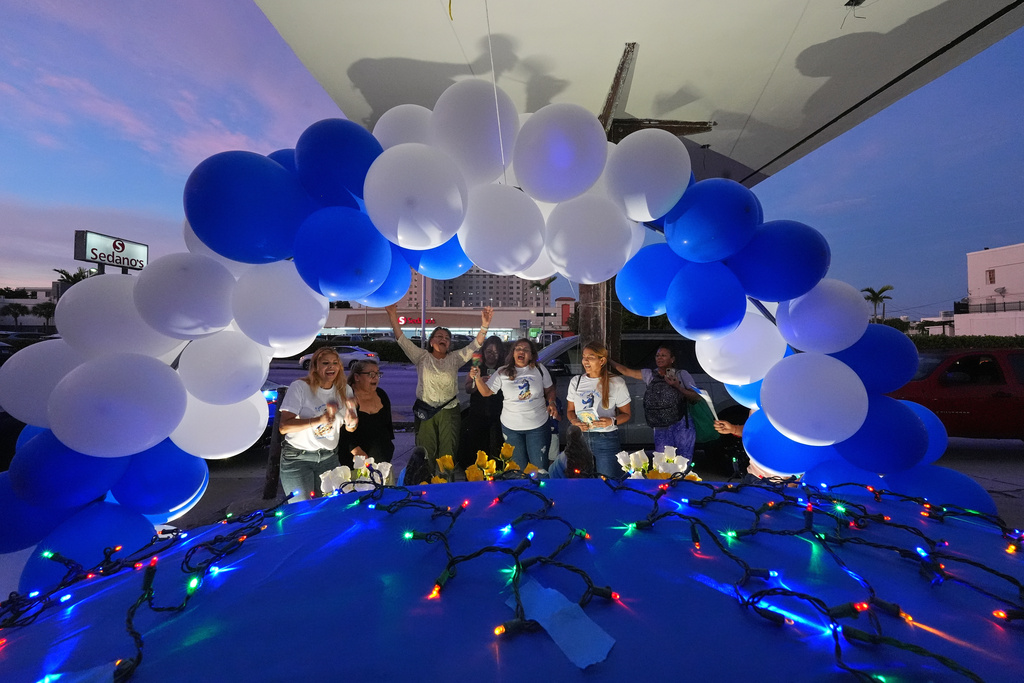 Nicaraguans sing in praise of the Virgin Mary at one of dozens of open-air altars set up near St. John Bosco Catholic Church in celebration of the Dec. 8 feast of the Immaculate Conception, Sunday, Dec. 7, 2025, in Miami. (AP Photo/Rebecca Blackwell)