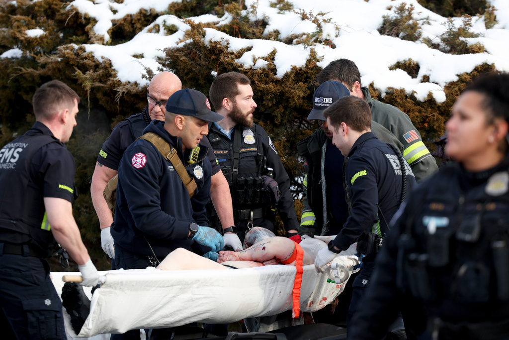 UPDATES INFORMATION ON PERSON GETTING AID: Emergency medical technicians administer aid to a person who was shot by a Immigration and Customs Enforcement officer in Minneapolis on Wednesday, Jan. 7, 2026. (Ellen Schmidt/MinnPost via AP)