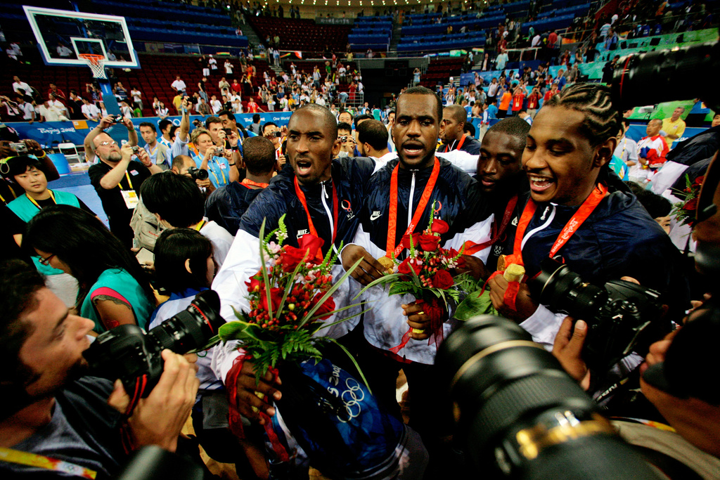 FILE - USA's, from left, Kobe Bryant, LeBron James, Dwyane Wade and Carmelo Anthony face photographers as they celebrate after beating Spain in the men's gold medal basketball game at the 2008 Olympics in Beijing, Aug. 24, 2008. (AP Photo/Dusan Vranic, File)