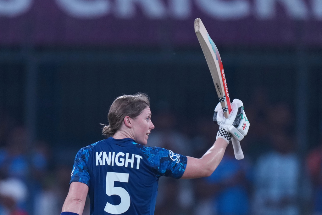 England's Heather Knight celebrates her century during the ICC Women's Cricket World Cup match between India and England in Indore, India, Sunday, Oct. 19, 2025. (AP Photo/Ajit Solanki)