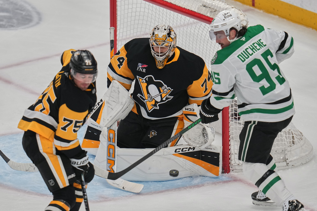 Pittsburgh Penguins goaltender Stuart Skinner (74) blocks a shot with Connor Clifton (75) defending as Dallas Stars' Matt Duchene (95) looks for the rebound during the first period of an NHL hockey game in Pittsburgh, Saturday, March 28, 2026. (AP Photo/Gene J. Puskar)