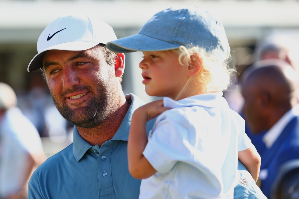 Scottie Scheffler holds his child Bennett after winning the PGA Tour Championship golf tournament Sunday, Aug. 30, 2026, in Atlanta. (AP Photo/Colin Hubbard)