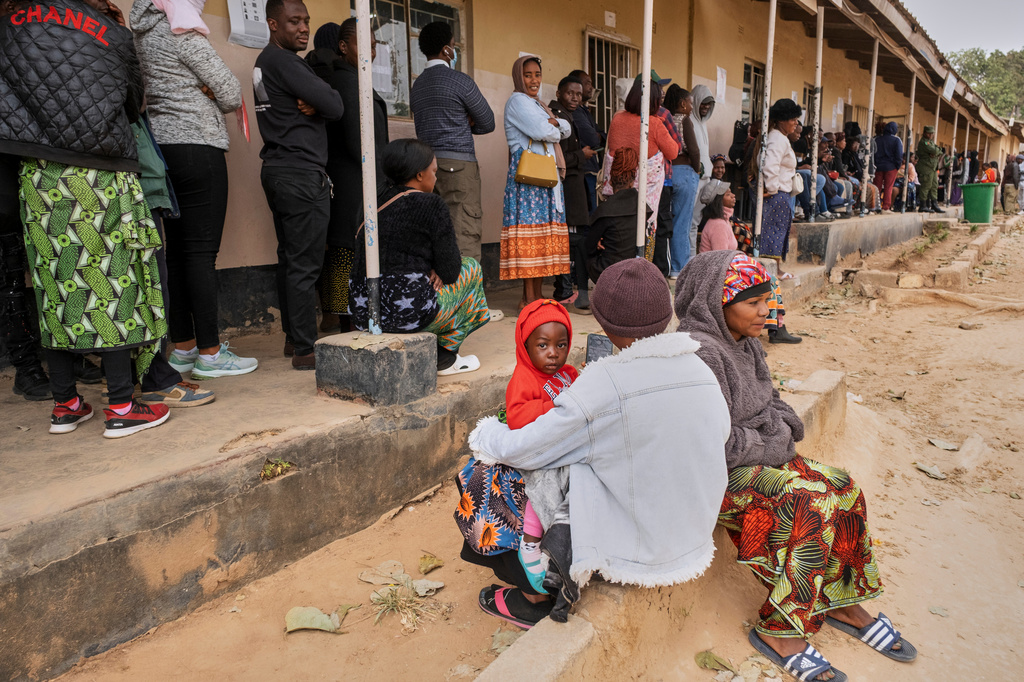 People queue up outside a polling station during a presidential election in Lusaka, Zambia, Thursday, Aug. 13, 2026. (AP Photo/Anita Reed)