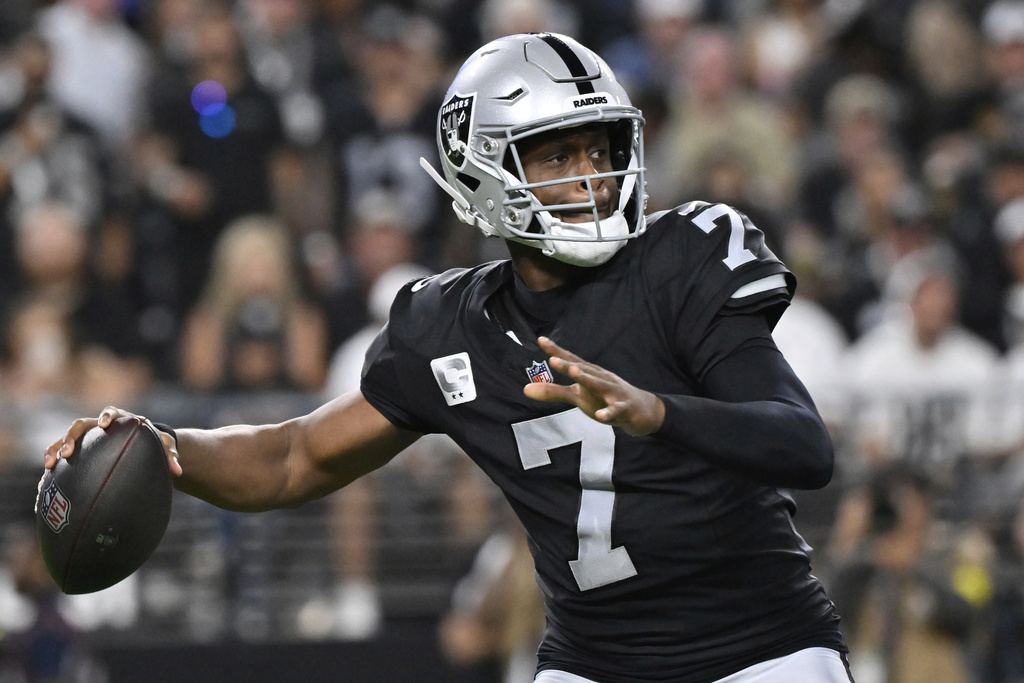 Las Vegas Raiders quarterback Geno Smith (7) throws against the Los Angeles Chargers before an NFL football game, Monday, Sept. 15, 2025, in Las Vegas. (AP Photo/David Becker)