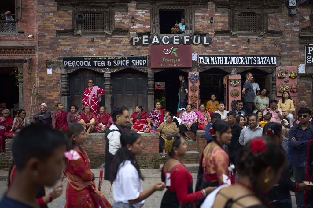 People watch a parade celebrating the birthday of Lord Krishna on Krishna Janmashtami in Bhaktapur,Nepal, Saturday, Aug. 16, 2025. (AP Photo/Niranjan Shrestha)