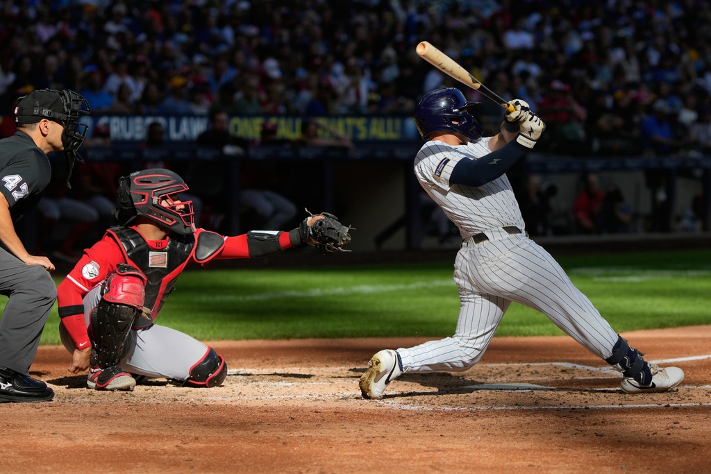 Milwaukee Brewers' Danny Jansen hits a two-run home run during the fourth inning of a baseball game against the Cincinnati Reds Sunday, Sept. 28, 2025, in Milwaukee. (AP Photo/Morry Gash)