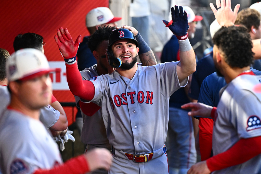 Boston Red Sox's Wilyer Abreu, center, is greeted by teammates after scoring during the fifth inning of a baseball game against the Los Angeles Angels, Saturday, July 4, 2026, in Anaheim, Calif. (AP Photo/William Liang)