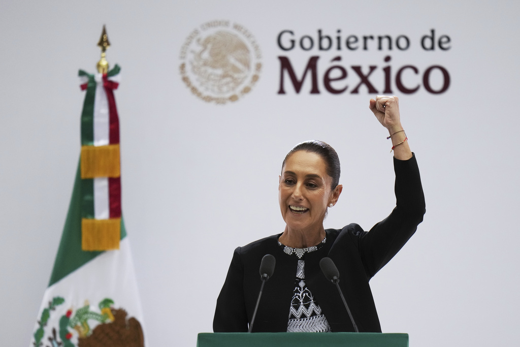 Mexican President Claudia Sheinbaum raises her fist at the end of her first state-of-the-nation address at the National Palace in Mexico City, Monday, Sept. 1, 2025. (AP Photo/Eduardo Verdugo)