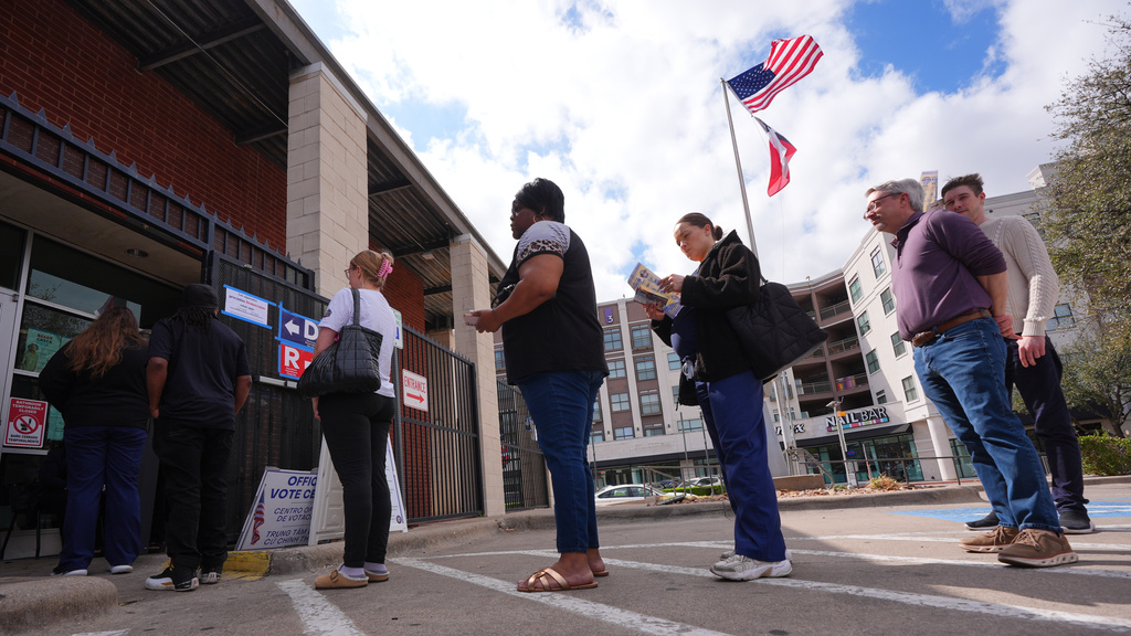 Primary voters line up to cast ballots at a voting center in Dallas, Tuesday, March 3, 2026. (AP Photo/LM Otero)