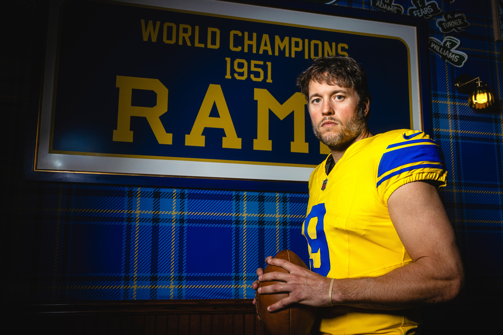 This undated photo provided by the Los Angeles Rams, Thursday, July 23, 2026, shows quarterback Matthew Stafford posing in Los Angeles wearing the Rams’ new “Classic Sol” alternate uniform. (Brevin Townsell/Los Angeles Rams via AP)