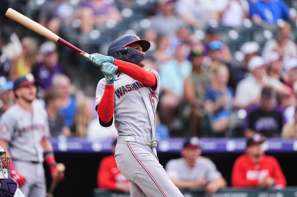Washington Nationals' CJ Abrams follows the flight of his two-run home run off Colorado Rockies starting pitcher Michael Lorenzen in the first inning of a baseball game Tuesday, July 21, 2026, in Denver. (AP Photo/David Zalubowski)