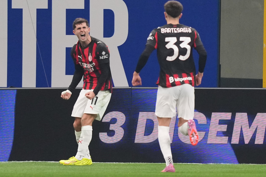AC Milan's Christian Pulisic celebrates after scoring during the Serie A soccer match between Inter Milan and AC Milan in Milan, Italy, Sunday, Nov. 23, 2025. (AP Photo/Antonio Calanni)
