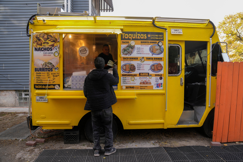 Rafael Hernandez, originally from Mexico, sells food from his family's food truck, Nov. 6, 2025, in Chicago. (AP Photo/Erin Hooley)