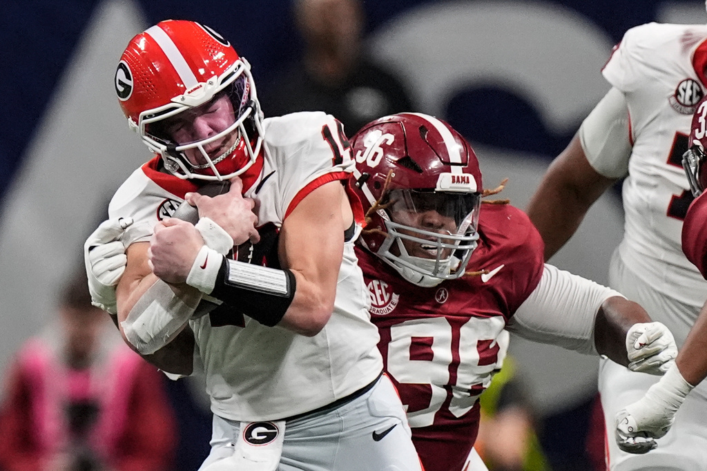 FILE - Georgia quarterback Gunner Stockton (14) runs against Alabama during the second half of a Southeastern Conference championship NCAA college football game in Atlanta, Dec. 6, 2025. (AP Photo/Mike Stewart, File)