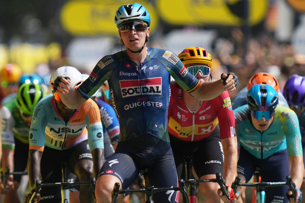 Belgium's Tim Merlier celebrates as he crosses the finish line to win the seventh stage of the Tour de France cycling race with start in Hagetmau and finish in Bordeaux, France, Friday, July 10, 2026. (AP Photo/Thibault Camus)
