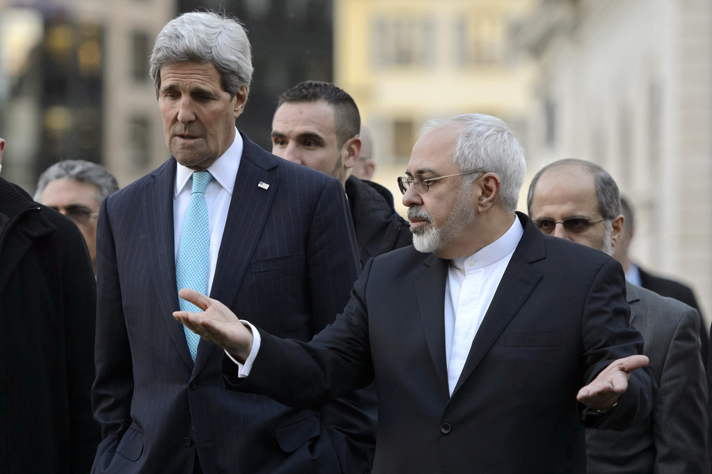FILE - US Secretary of State John Kerry, left, listens to Iranian Foreign Minister Mohammad Javad Zarif, as they walk in the city of Geneva, Switzerland, Jan. 14, 2015, during a bilateral meeting ahead of the next round of nuclear discussions. (AP Photo/Keystone, Martial Trezzini, File)