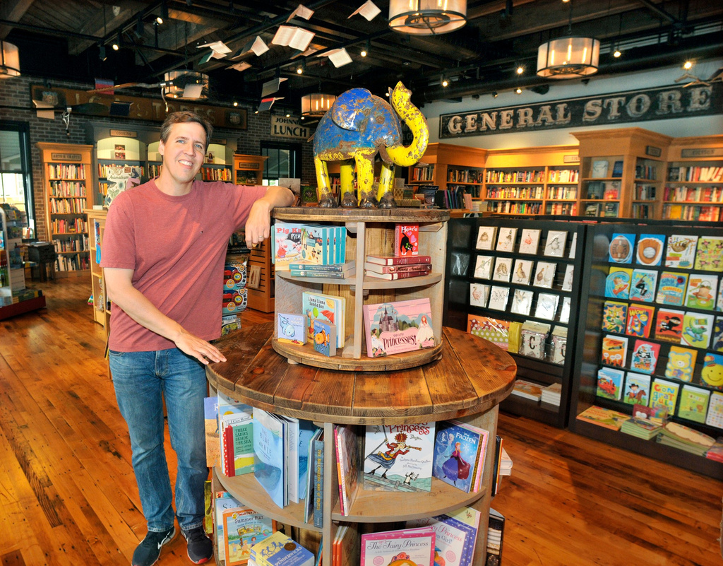 FILE - Author Jeff Kinney poses at his "An Unlikely Story" bookstore in downtown Plainville, Mass., on May 27, 2015. (Tom Maguire/The Sun Chronicle via AP, File)