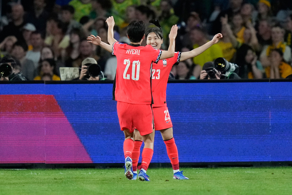 South Korea's Kang Chae-rim, right, is congratulated by teammate Kim Hye-ri after scoring her team's third goal during the Women's Asian Cup soccer match between Australia and South Korea in Sydney, Sunday, March 8, 2026. (AP Photo/Rick Rycroft)