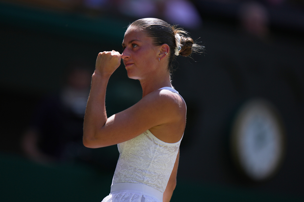 Marta Kostyuk of Ukraine celebrates a point against Jasmine Paolini of Italy, in their quarter-final women's singles match at the Wimbledon Tennis Championships in London, Wednesday, July 8, 2026. (AP Photo/Brian Inganga)
